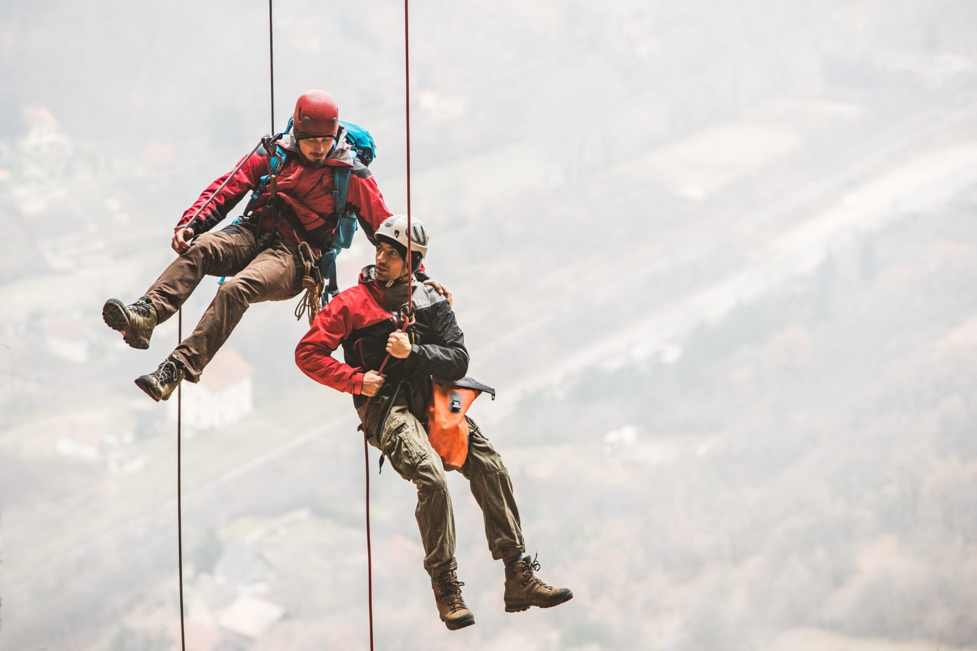 Two climbing partners rappelling together