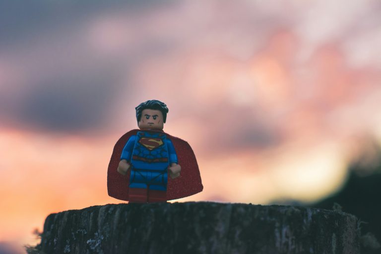 Superman toy standing in the sunset