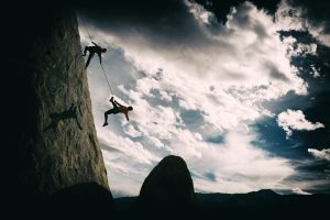 Two climbers suspended from a rock face