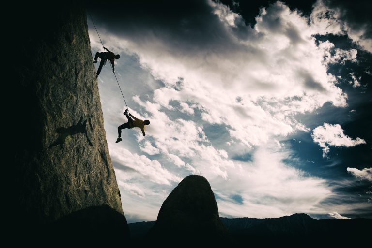 Two climbers suspended from a rock face